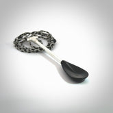 This pendant is a hand carved boat paddle. We have carved this with a Black jade blade or a green jade blade with sterling silver handle. Provided with an adjustable cord.